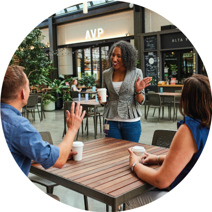 3 individuals chatting over coffee